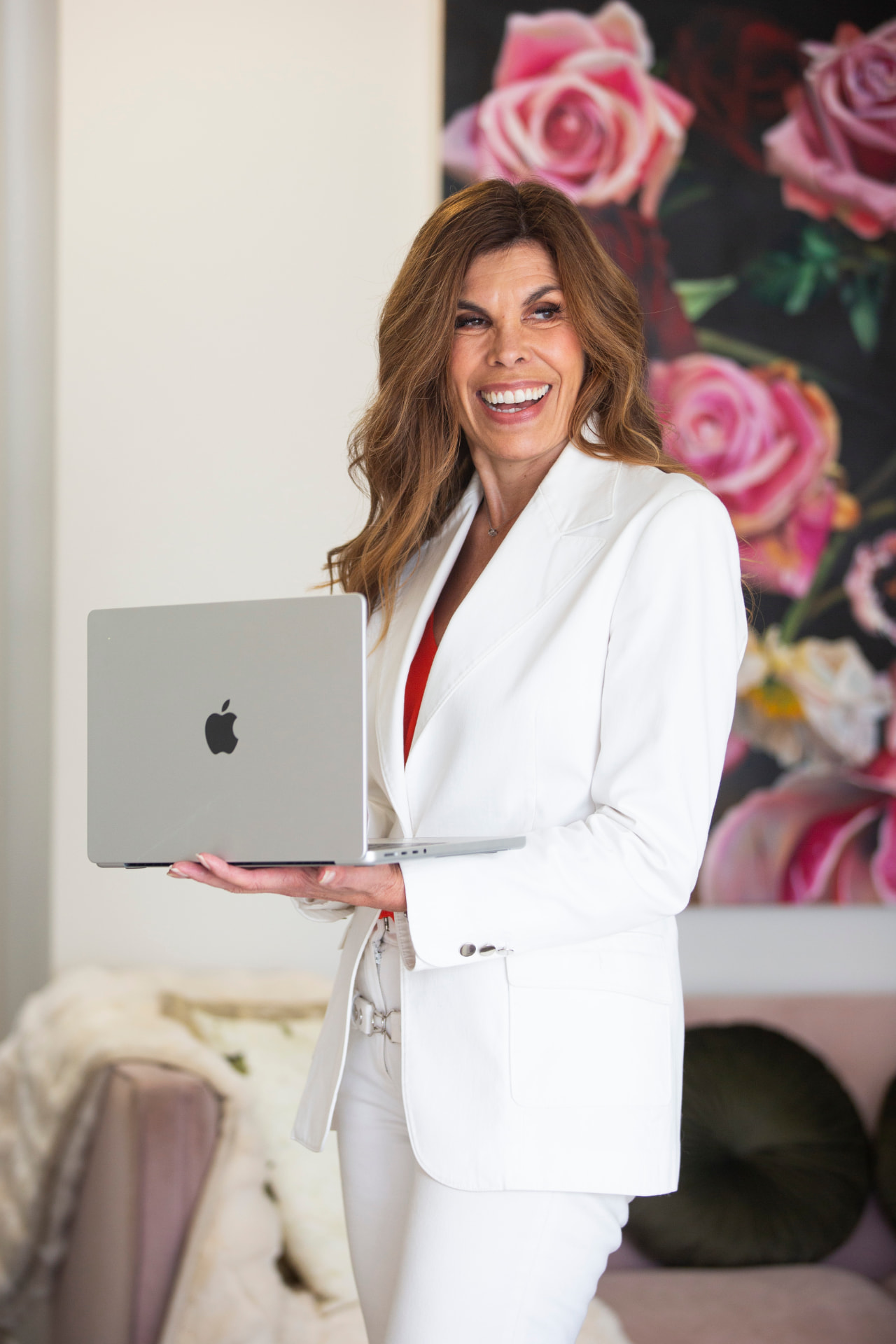 Sarah Sparks with laptop in a bright, modern office space